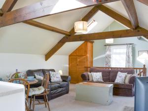 a living room with a couch and a table at Summertree Farm The Granary in Thornton Dale