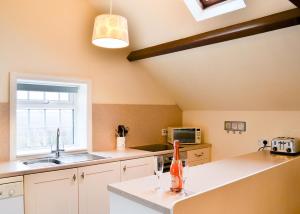 a kitchen with a sink and a counter top at Summertree Farm The Granary in Thornton Dale