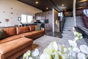 a living room with a couch and a kitchen at Bay View Villa in Gardur