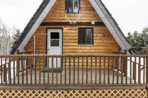 a log cabin with a porch and a door at The Papa Bear Cabin - Bear Creek Cabins in Winfield