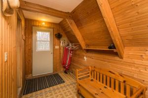 a wooden room with a door and a bench at The Papa Bear Cabin - Bear Creek Cabins in Winfield