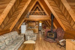 a living room with a couch and a wood stove at The Papa Bear Cabin - Bear Creek Cabins in Winfield +18 photos