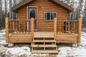 a cabin in the woods in the snow at The Sheep Camp cabin- Bear Creek Cabins in Winfield