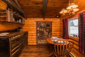 a dining room with a table and chairs in a cabin at The Sheep Camp cabin- Bear Creek Cabins in Winfield +31 photos