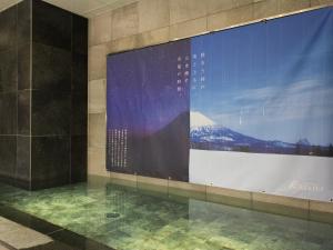 a large screen on a wall in a building at HOTEL RELIEF Sapporo Susukino in Sapporo