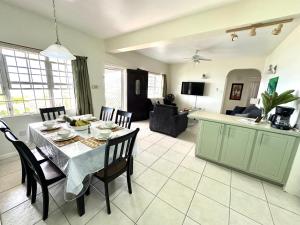 a kitchen and living room with a table and chairs at Krysta's Hideaway in Basseterre