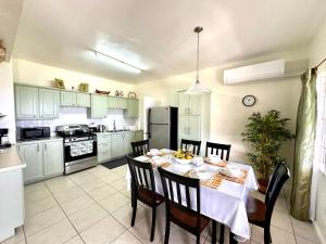 a kitchen with a table and chairs and a kitchen with a refrigerator at Krysta's Hideaway in Basseterre