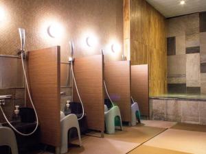 a bathroom with a row of urinals and toilets at HOTEL RELIEF Sapporo Susukino in Sapporo +20 photos