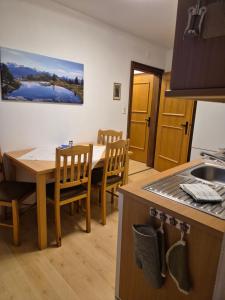 a kitchen with a table and chairs in a kitchen at Winklgut Bacher in Uttendorf