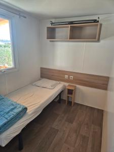 a small room with two beds and a window at camping siblu le montourey fréjus in Fréjus +12 photos