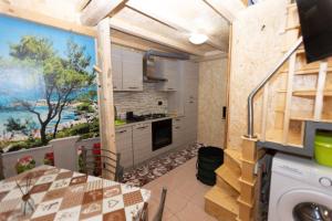 a kitchen with a table and a view of the ocean at Mini casa a 30 mt dalla spiaggia in Catania