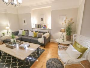 a living room with a couch and a table at Bwthyn Mawr in Harlech