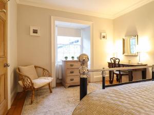 a bedroom with a bed and a desk and a chair at Bwthyn Mawr in Harlech