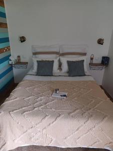 a large bed with a plate on top of it at La paillote des Ninous in Bassan +11 photos