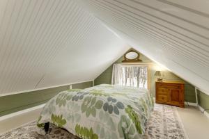 a attic bedroom with a bed and a window at Killingly Barnyard Studio in Wine Country! in Pineville