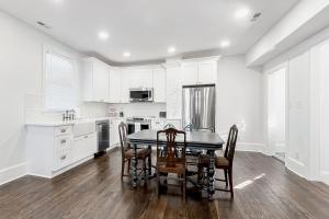 a kitchen with white cabinets and a table and chairs at Pets Welcome! Family-Friendly Retreat in Culpeper in Culpeper +16 photos