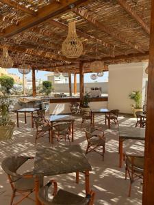 a group of tables and chairs under a pavilion at بورتو سخنه in Ain Sokhna