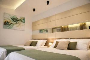 a hotel room with two beds with white sheets at Resort Comfort - Long Beach in Ulcinj +72 photos