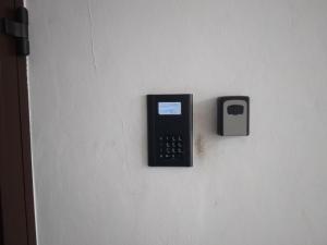 a cell phone on a wall with a switch at ABCD Apartments Centrum in Biała Podlaska