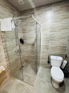 a bathroom with a shower and a toilet at Montis Resort in Yeghegis +24 photos