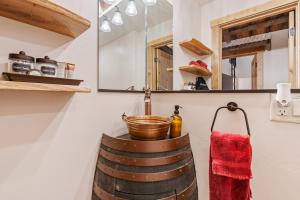 a bathroom with a barrel sink and a mirror at Historic Yellowstone Saloon in Ashton +67 photos