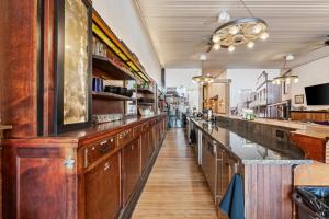 a bar with wooden cabinets and a long aisle at Historic Yellowstone Saloon in Ashton