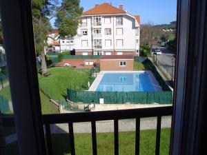 a view of a swimming pool from a window at Piso de Gama in Gama