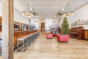 a restaurant with a bar with a piano at Historic Yellowstone Saloon in Ashton