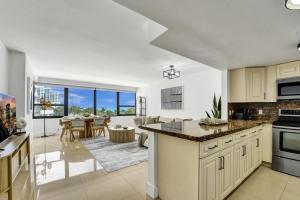 an open kitchen and living room with a large window at Large Ocean View 2 BDR Condo Beachfront Hotel 504 in Miami Beach