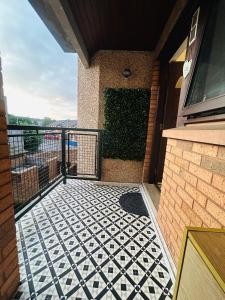 a balcony with a black and white tile floor at Modern & cozy 2 bedroom flat in Dundee