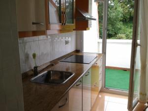 a kitchen with a sink and a window at Piso de Gama in Gama