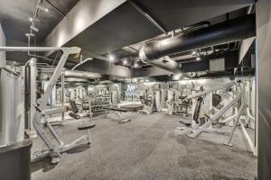 a gym with several treadmills and machines at Large Ocean View 2 BDR Condo Beachfront Hotel 504 in Miami Beach