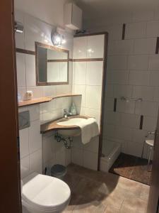 a bathroom with a sink and a toilet and a tub at Kurring 4 Apartment 105 in Bad Rodach