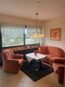 a living room with two couches and a table at Kurring 4 Apartment 105 in Bad Rodach