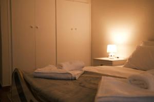 a bedroom with two towels sitting on a bed at The Sunny Side Apartment in Florina
