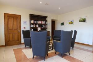 a waiting room with chairs and a book shelf at HOTEL DE LA GARE in Bar-le-Duc