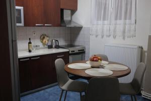a kitchen with a table with a bowl of fruit on it at The Sunny Side Apartment in Florina
