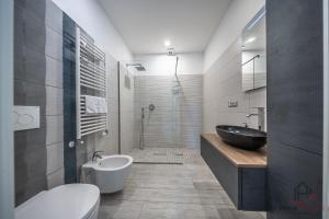 a bathroom with a sink and a toilet and a shower at Modern Central Space - Mare 5 min - AC - WiFi in Savona +22 photos
