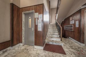 a hallway with stairs in a building with wooden walls at Modern Central Space - Mare 5 min - AC - WiFi in Savona