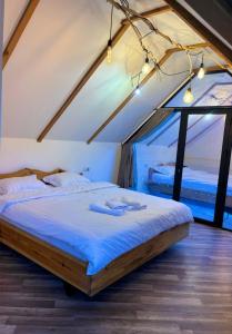 a bed in a room with a large window at Montis Resort in Yeghegis