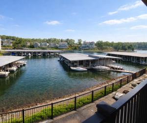 a group of boats docked at a dock on a river at Blueys Lakefront 2 Bed and 2 Bath Condo in Abbeyville