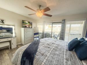 a bedroom with a bed and a ceiling fan at Blueys Lakefront 2 Bed and 2 Bath Condo in Abbeyville +40 photos
