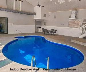 a large blue pool located in a community clubhouse at Blueys Lakefront 2 Bed and 2 Bath Condo in Abbeyville