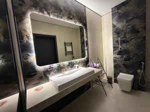 a bathroom with a sink and a mirror at U Dominicana in Kamianets-Podilskyi +168 photos