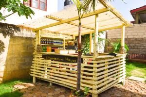 a wooden kiosk in the yard of a house at Utamaduni House B&B in Arusha