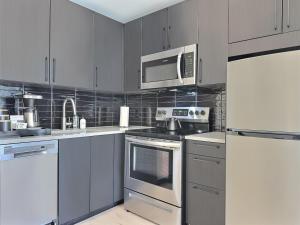 a kitchen with stainless steel appliances and a microwave at Modern Studio, Gym, Near UAB in Birmingham