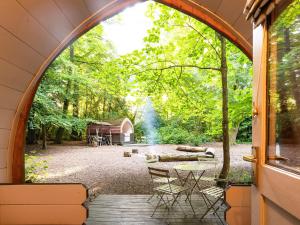 an arched window of a tent with a picnic table and a barn at Bluebelle - Ukc5928 in Highclere