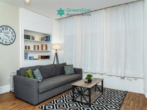 a living room with a couch and a table at GreenStar Apartments - Short Walk Away Into Dundee City Centre - 6 Individual Properties from 1 to 3 Bedrooms - Short & Long Stay Offers! in Dundee