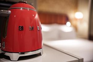 a red toaster sitting on top of a counter at Olympia Lis Baixa Hotel in Lisbon +48 photos
