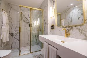a bathroom with a sink and a shower at Olympia Lis Baixa Hotel in Lisbon